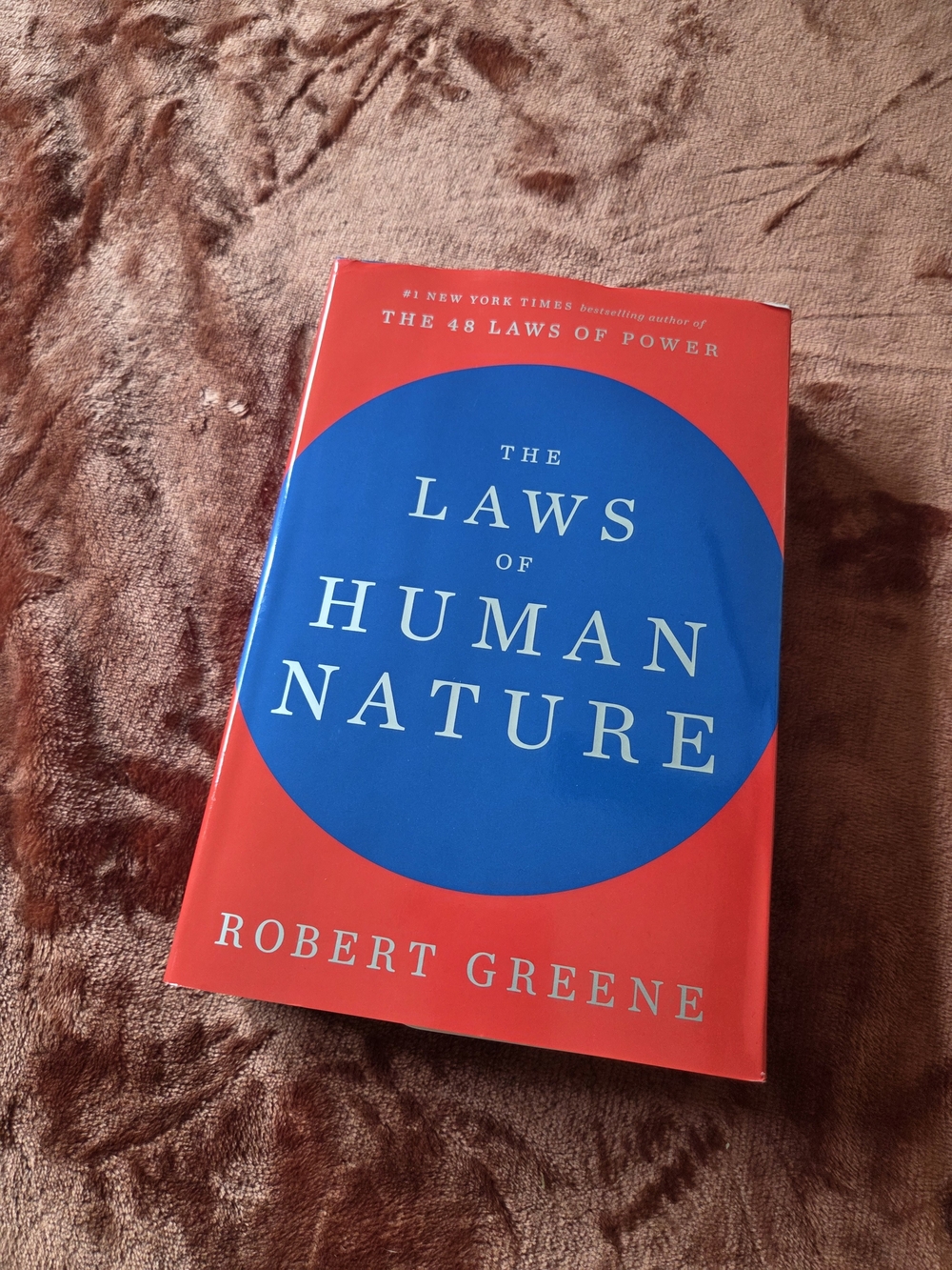 The Laws of Human Nature by — Blue and Red Hardcover Edition